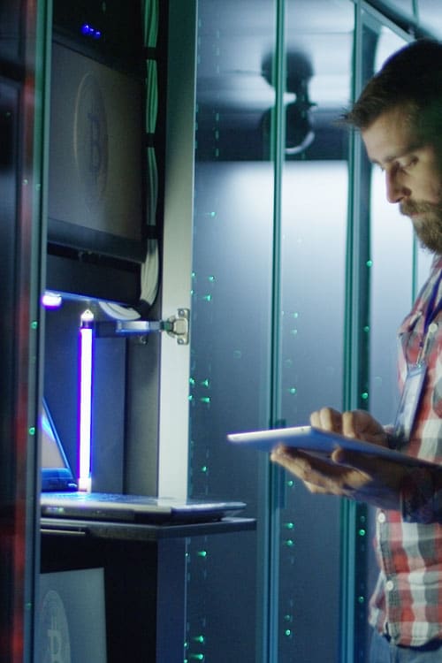 A man looking at a tablet as he provides fast secure web hosting
